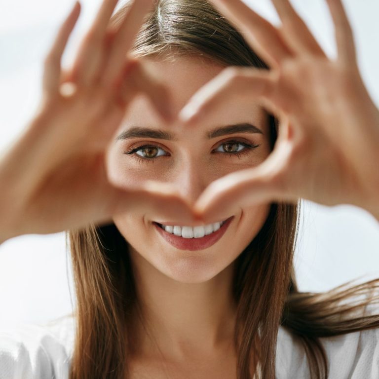 Woman holding her hands in a heart shape