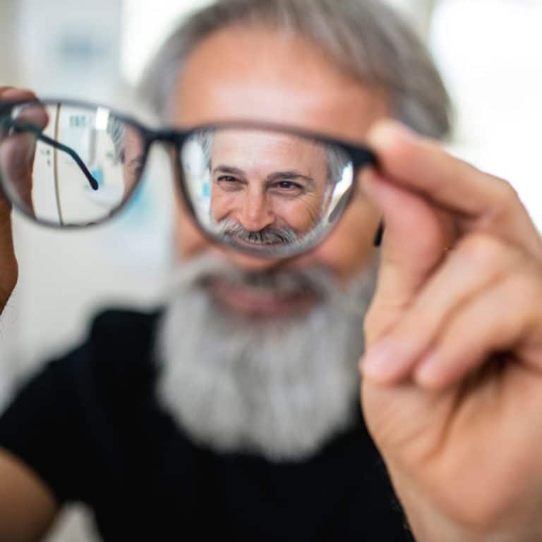 Looking Through Glasses At A Man