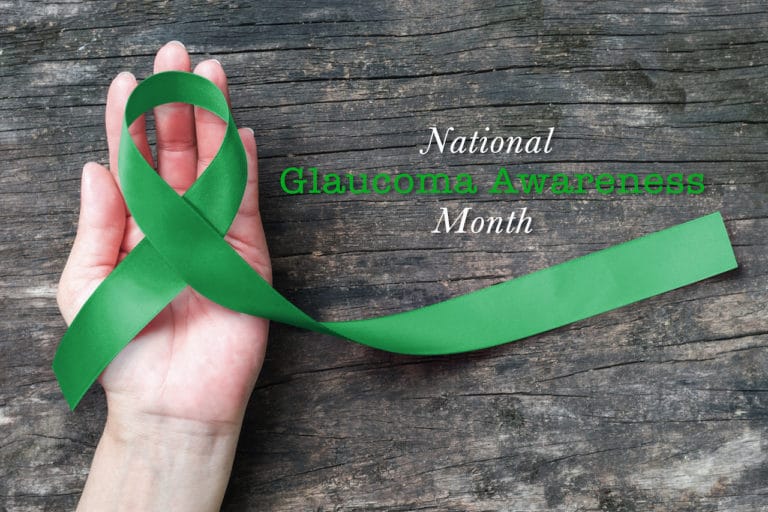 National Glaucoma Awareness Month in January with Green ribbon on helping hand