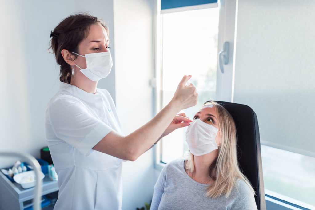 Young woman having BLEPHEX® treatment at ophthalmologist's office