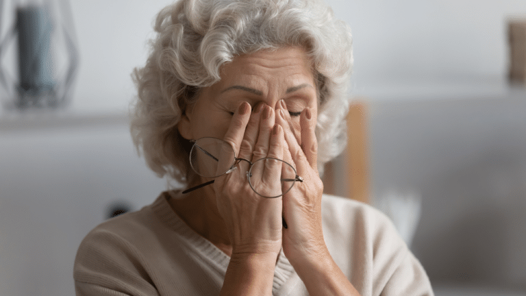 Senior woman rubbing her eyes