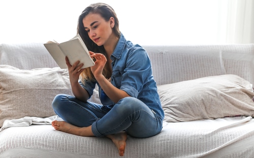 Woman on a couch reading a book